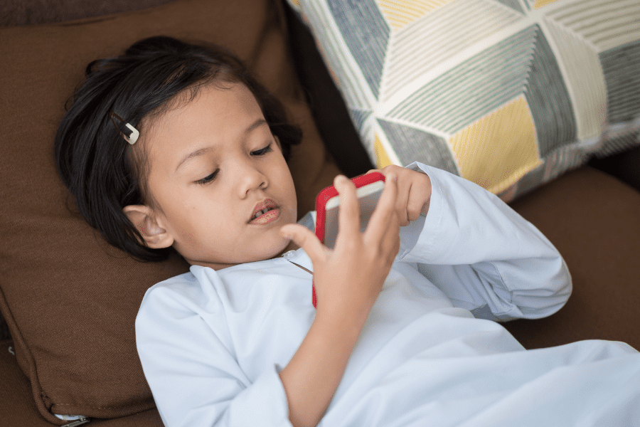 a child playing on a mobile phone -  screen time