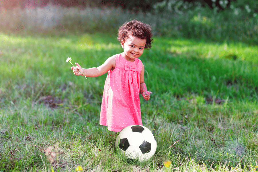 2-year-old playing outside with a ball
