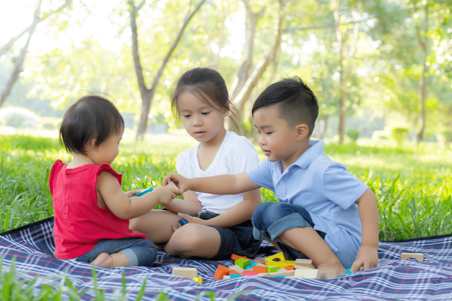 toddlers having a picnic outside