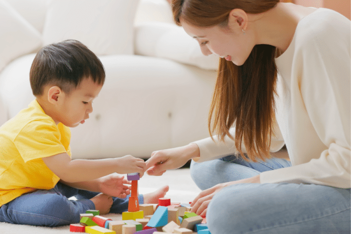 mom playing blocks with toddler